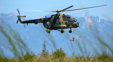 Soldiers fast rope from transport helicopters