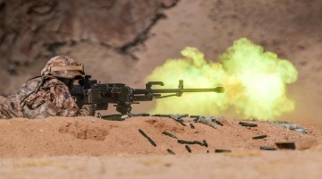Soldiers fire with multi-type arms 