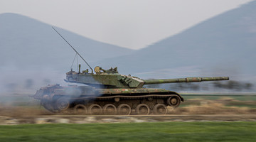 MBT rumbles in smoke and dust