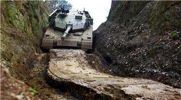 Type-96 MBTs pass through shallow trench
