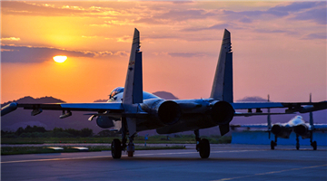 Fighter jets taxi to runway at sunset