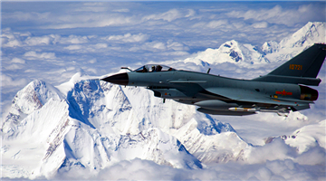 Fighter jet flies over mountains and sea