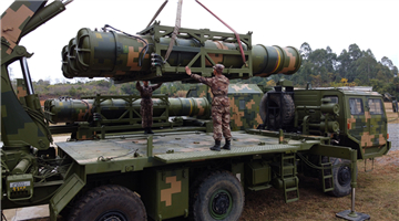 Soldiers load air-defense missiles