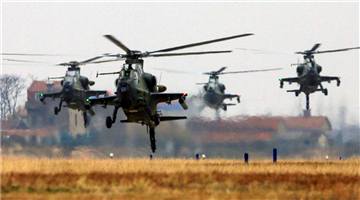 Attack helicopters lift off from parking apron