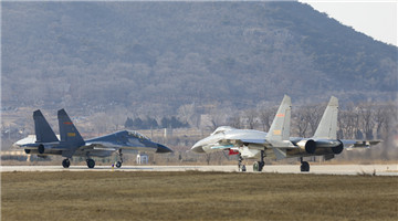 Fighter jets taxi in close formation before takeoff