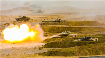 Armored vehicles engage mock enemy targets