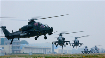 Attack helicopters lift off from parking apron