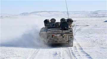 Soldiers drive armored vehicles on snow ground