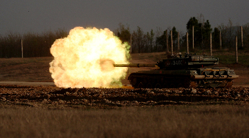 Tanks attack mock targets during live-fire training
