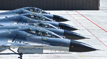 Fighter jets sit abreast on the flightline